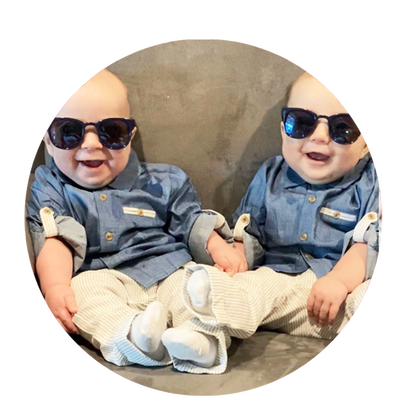 two baby boys wearing sunglasses